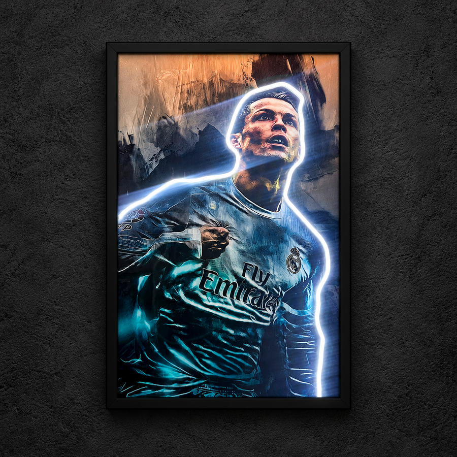 Framed Cristiano Ronaldo artwork showing Cristiano Ronaldo in a teal football shirt against an abstract background, with a white figure outline illuminated.